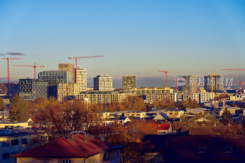Skyline of City of Zürich North on a sunny autumn morning with skyscrapers and construction sites.